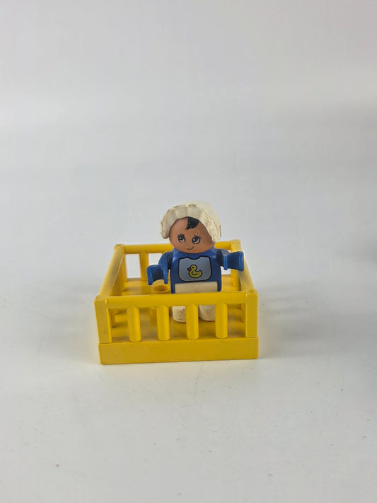 LEGO DUPLO baby figure inside a yellow playpen/crib