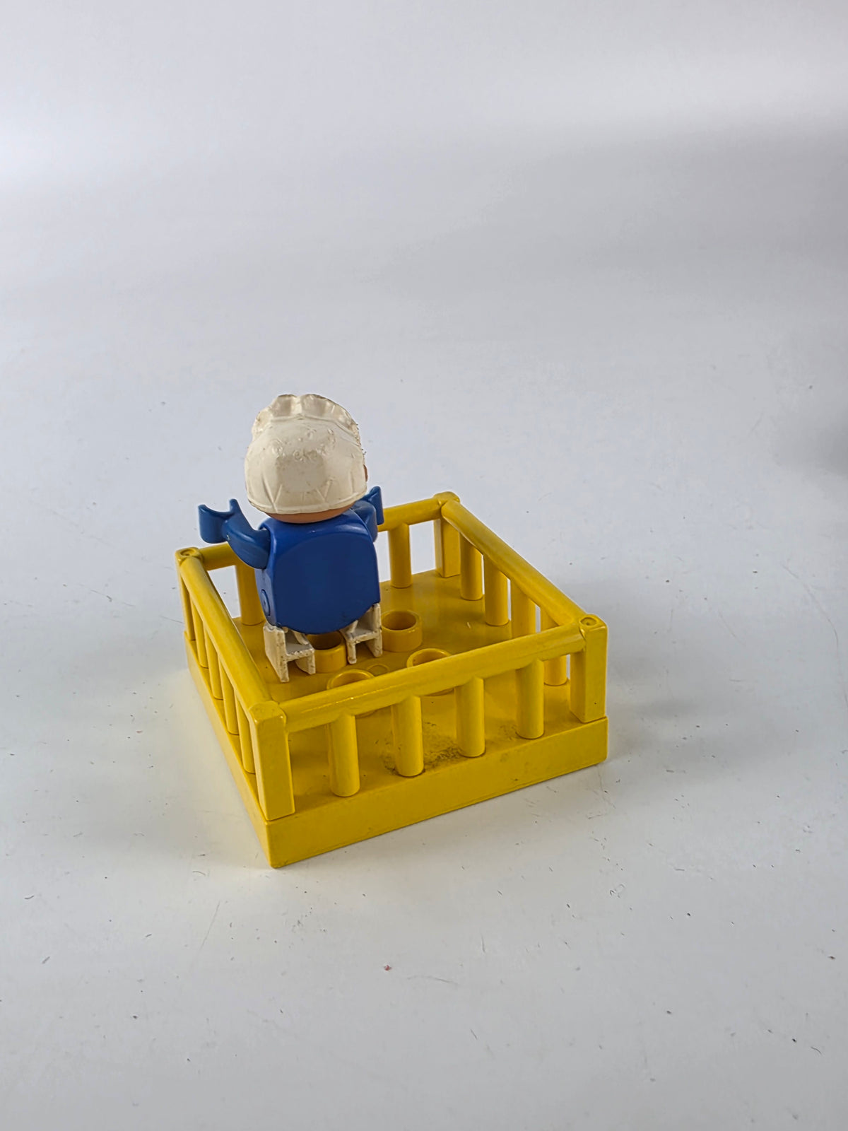 LEGO DUPLO baby figure inside a yellow playpen/crib